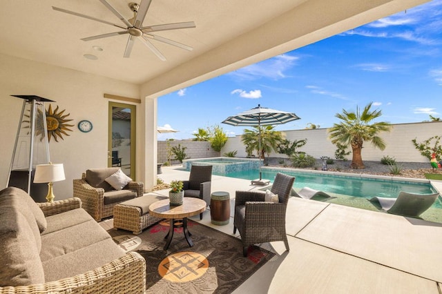 view of patio / terrace featuring ceiling fan, a pool with hot tub, and an outdoor hangout area