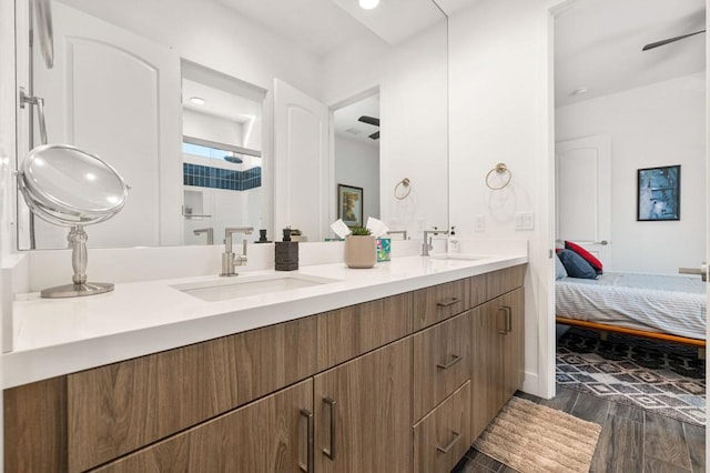 bathroom featuring ceiling fan, a shower, and vanity