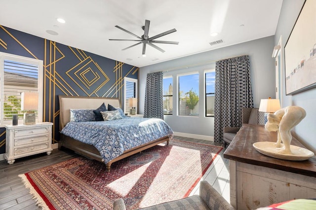 bedroom with ceiling fan, wood-type flooring, and multiple windows