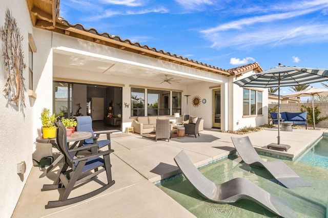 rear view of property with ceiling fan, an outdoor living space, a patio area, and a fenced in pool