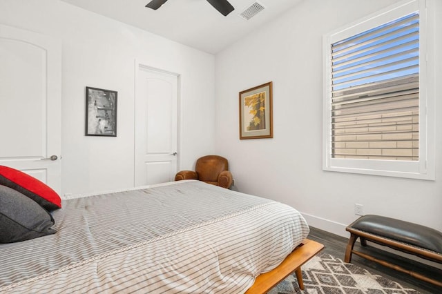 bedroom with ceiling fan, a closet, and wood-type flooring