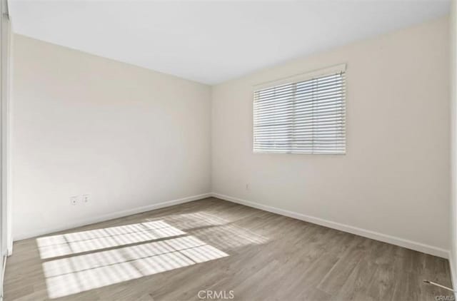 spare room with light hardwood / wood-style floors