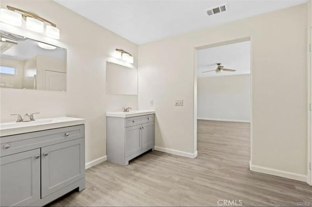 bathroom with vanity, hardwood / wood-style floors, and ceiling fan