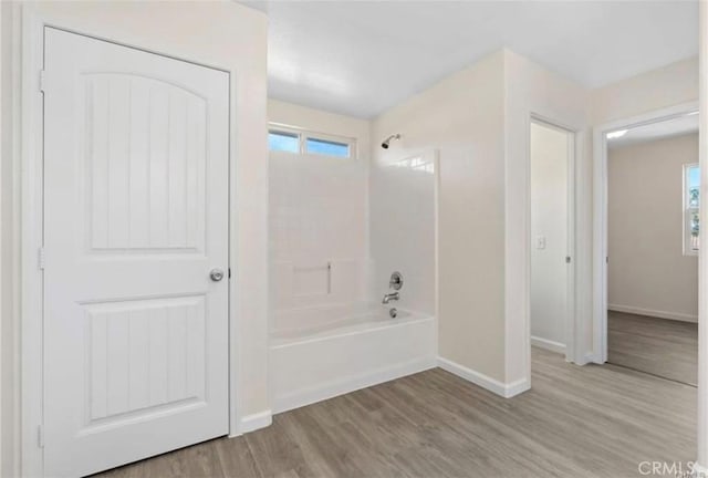 bathroom featuring hardwood / wood-style flooring and shower / bathtub combination