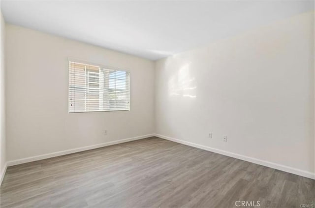 spare room featuring wood-type flooring