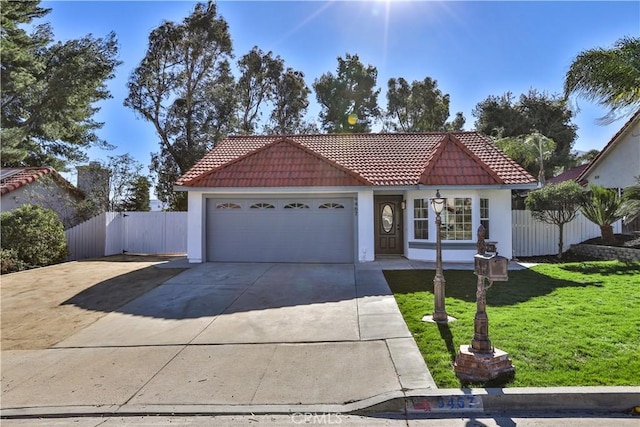 mediterranean / spanish house with a front yard and a garage