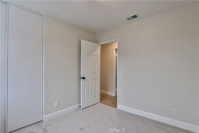 unfurnished bedroom with light carpet