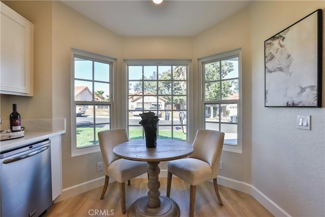 dining room featuring a healthy amount of sunlight and light hardwood / wood-style floors