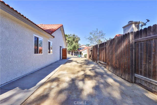 view of side of property with a patio area