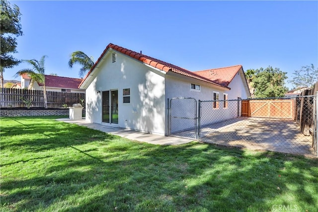 rear view of property featuring a yard