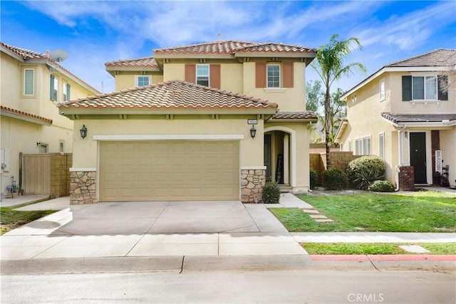 mediterranean / spanish home with a front lawn and a garage