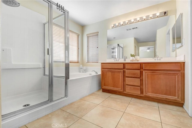 bathroom featuring independent shower and bath, tile patterned floors, and vanity