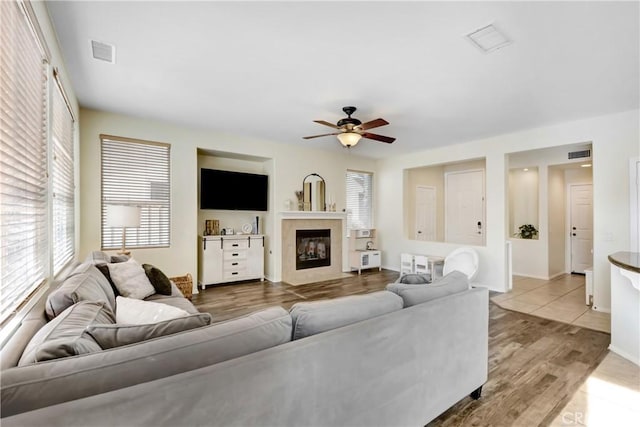 living room with ceiling fan and light hardwood / wood-style flooring