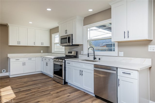 kitchen featuring sink, white cabinetry, and stainless steel appliances