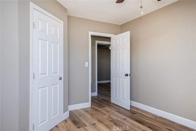 unfurnished bedroom featuring ceiling fan and hardwood / wood-style floors