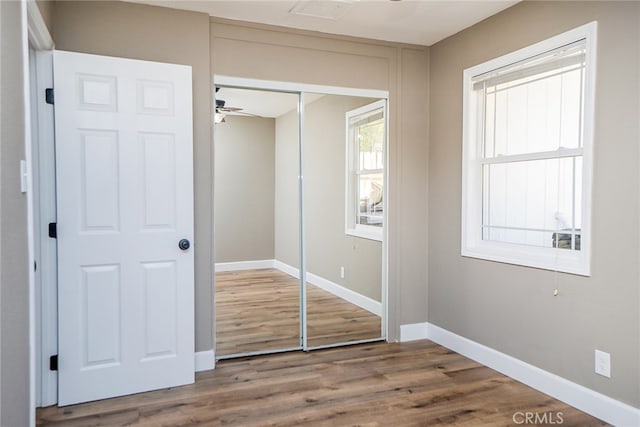 unfurnished bedroom with hardwood / wood-style flooring and a closet