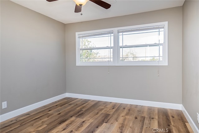 unfurnished room with ceiling fan and wood-type flooring