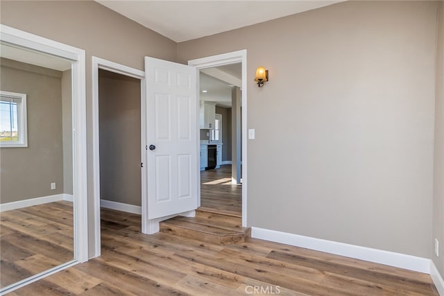 unfurnished bedroom featuring a closet and hardwood / wood-style floors