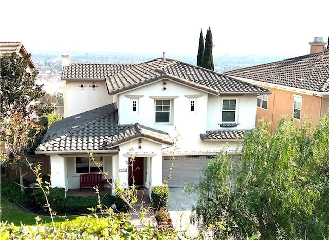 mediterranean / spanish home with a garage