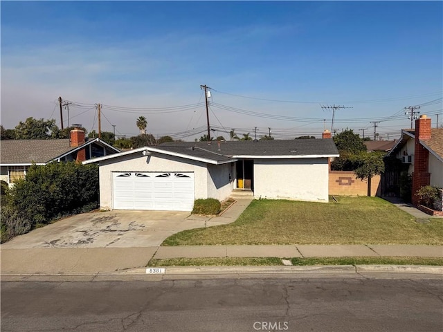 ranch-style house with a garage and a front yard