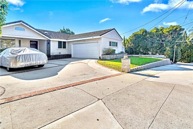 ranch-style house featuring a front yard and a garage