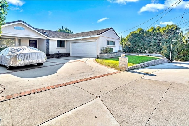 ranch-style home with a front lawn and a garage