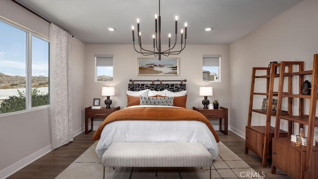 bedroom featuring dark wood-type flooring and a notable chandelier