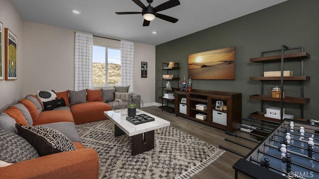 living room featuring ceiling fan and dark hardwood / wood-style flooring