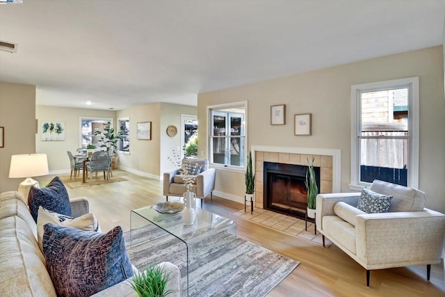 living room with a fireplace and light hardwood / wood-style floors