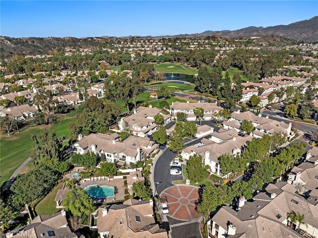 birds eye view of property with a water and mountain view