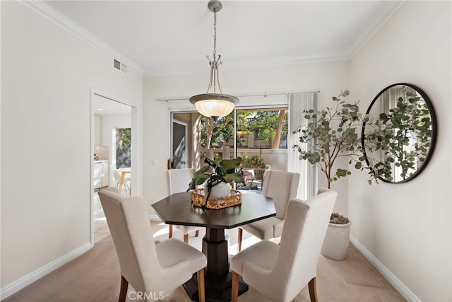 carpeted dining space featuring ornamental molding