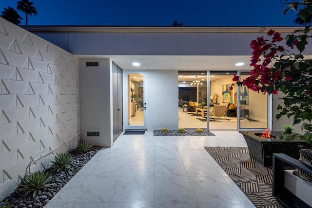 exterior entry at night with a patio