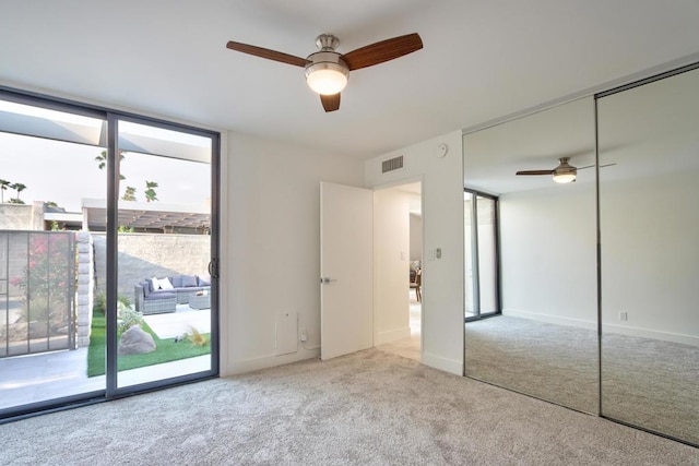 interior space with ceiling fan and expansive windows