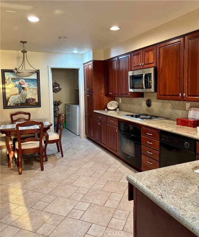 kitchen with light stone counters, hanging light fixtures, black appliances, and tasteful backsplash