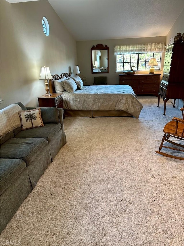 bedroom featuring vaulted ceiling and carpet