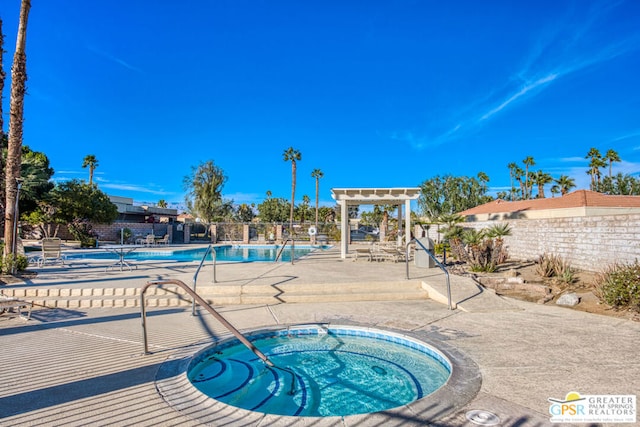 view of swimming pool with a community hot tub and a patio area