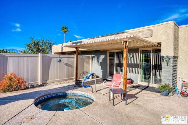 exterior space featuring an in ground hot tub, a patio, and a pergola