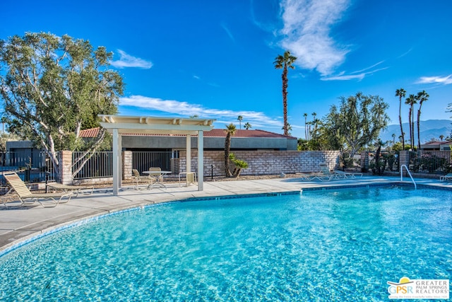 view of pool featuring a mountain view and a patio