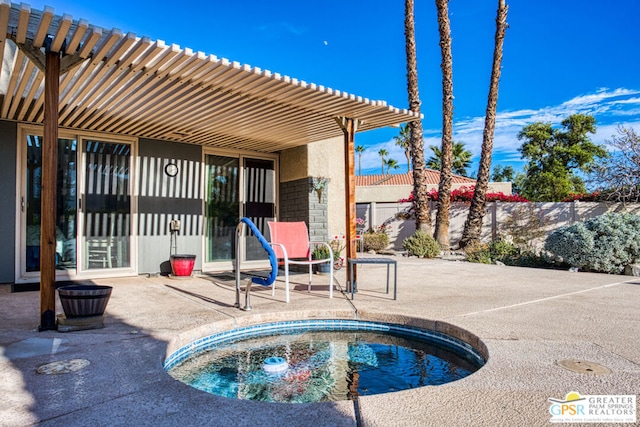 view of pool with a jacuzzi and a patio