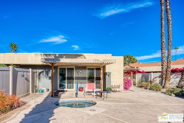 back of property featuring a patio and a pergola