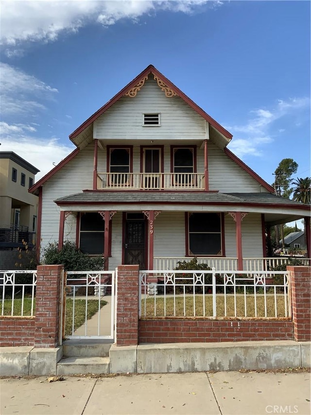 view of front of property with a porch and a balcony