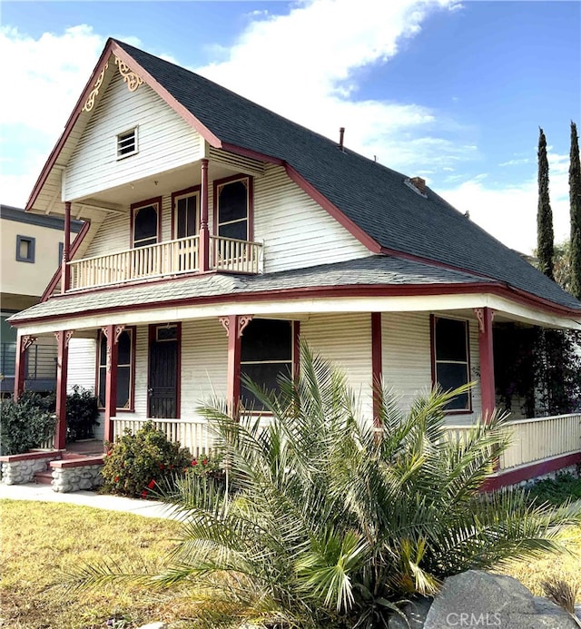 view of front facade featuring a balcony and a porch