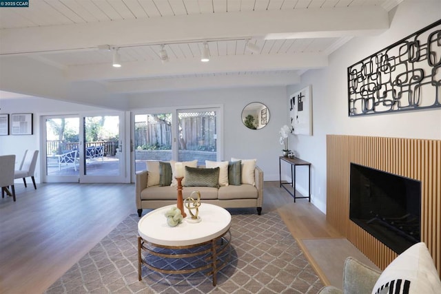 living room with rail lighting, hardwood / wood-style floors, beam ceiling, and wood ceiling