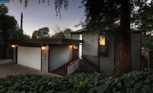 property exterior at dusk featuring a garage