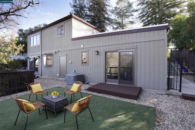 rear view of house featuring a patio area, a lawn, and central AC