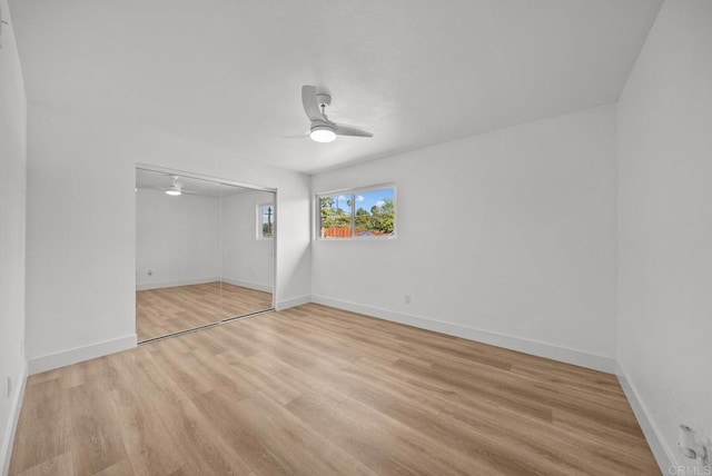 unfurnished bedroom with light wood-type flooring, a closet, and ceiling fan