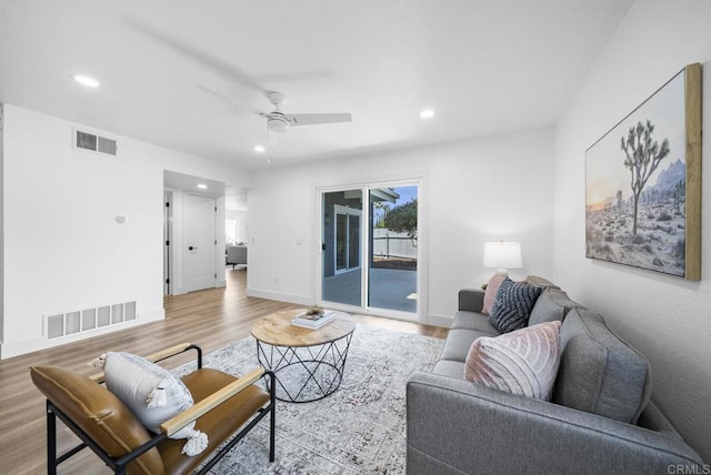 living room with ceiling fan and light wood-type flooring