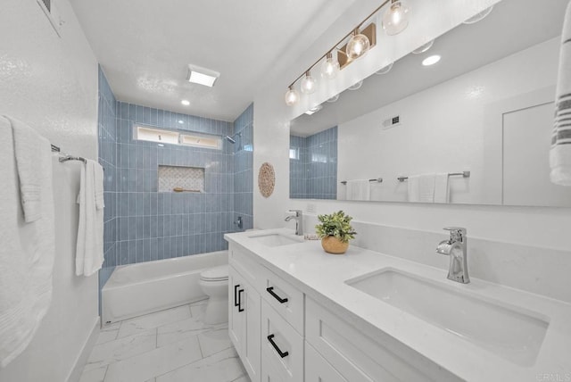 full bathroom featuring toilet, tiled shower / bath, and vanity