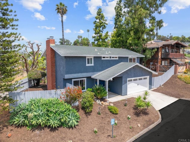 view of front facade with fence, driveway, an attached garage, stucco siding, and a chimney