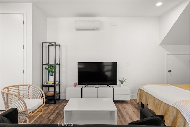 bedroom with dark hardwood / wood-style flooring and a wall unit AC